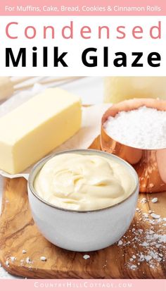 a wooden cutting board topped with cheese and cream