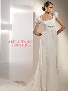 a woman in a white wedding dress standing next to a wall with the words adelle tailor boutique on it