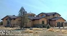 a large house with lots of windows in the front yard