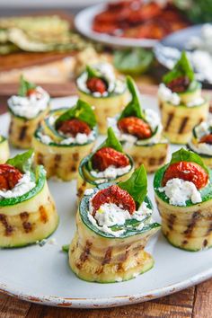 small appetizers are arranged on a white plate