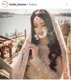 a woman in a bridal gown with flowers on her head and veil over her face