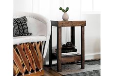 a small wooden table sitting next to a white couch