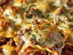 a close up view of a cheesy dish with meat, cheese and sauce