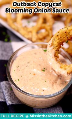 an onion rings dipping sauce in a small glass bowl with the text, outback copycat blooming onion sauce