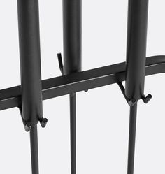 an image of a metal fence that is close to the ground and has two bars on it