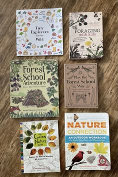 four children's books laid out on a wooden floor with the title forest school adventure