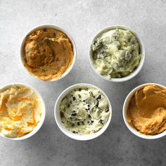 four bowls filled with different types of food on top of a white countertop next to each other