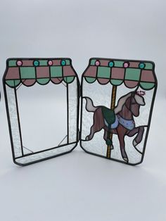 two stained glass mirrors depicting a carousel horse