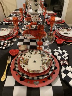 a black and white checkered table with red plates