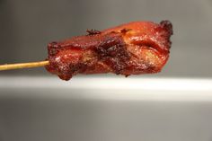 a piece of meat on a stick with toothpicks sticking out of it's end