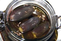 pickled eggplant in jar filled with water and sunflower seeds on table