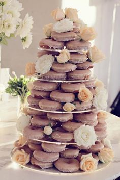 a wedding cake made out of doughnuts and flowers