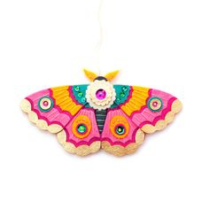 a colorful butterfly ornament hanging from a string on a white background with the words supply kit above it