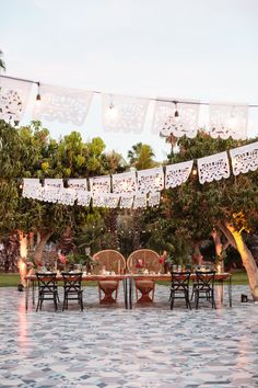 an outdoor dining area with tables and chairs set up for a party or gathering in the water