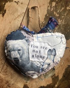 a piece of fabric with an image of a polar bear and the words you are not a lone on it