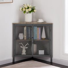 a book shelf with books and vases on top