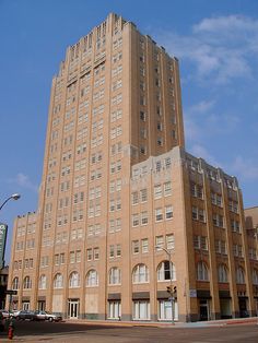 an old brick building with many windows on the front and side of it's face