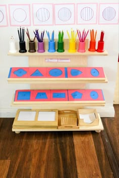 an art project is displayed on a shelf with markers and pencils in the background