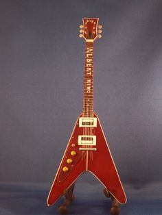 a red guitar shaped like an airplane