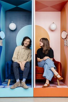 two people are sitting in a colorful room