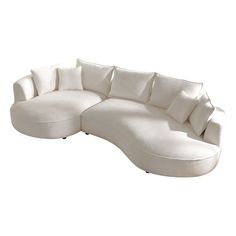 a large white sectional couch with pillows on the top and bottom part of it's head