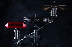 a red electronic drum set sitting on top of a black background