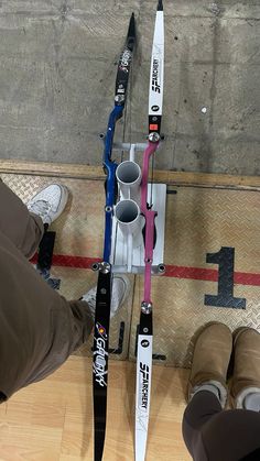 the skis are lined up against the wall and ready to be placed on the ground