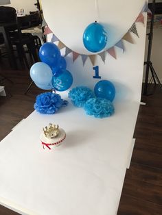 a cake and balloons are on a table