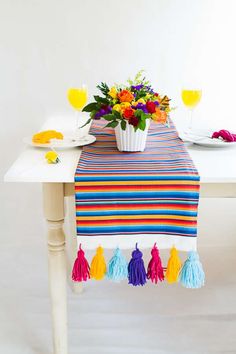 the table is decorated with colorful flowers and tassels