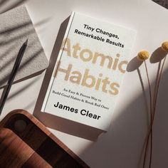 a book sitting on top of a white table next to a pair of black scissors