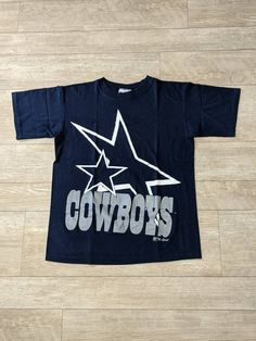 "Vintage 90s Dallas Cowboys Blue Single Stitch T-shirt. Has light wear. NO holes or major stains. In good vintage condition... Ready To Wear!! Size Med. Measurements: Pit to Pit: 20 3/4\" Collar to Bottom: 25 1/4\" Pit to End of Sleeve: 6 1/4\"" Blue Cotton Throwback T-shirt, 90s Blue Short Sleeve T-shirt, 90s Style Blue Short Sleeve T-shirt, Vintage Dallas Cowboys, Dallas Cowboys Shirts, Shirts Vintage, Mens Graphic Tee, Dallas Cowboys, Fancy Dresses