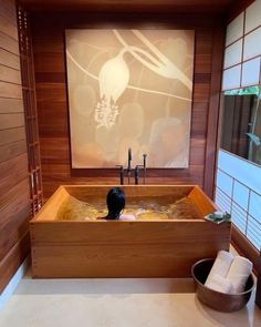 a large wooden bath tub sitting next to a window