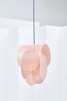 a pink light hanging from a blue cord in a room with white walls and flooring