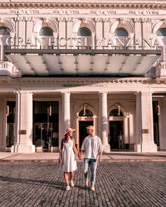 a man and woman walking in front of a building with the words your luxury stay in havana, cuba