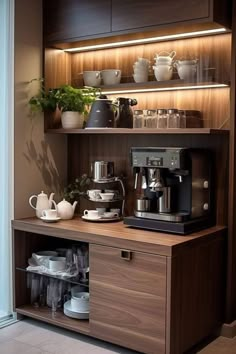 a coffee maker and some cups on a shelf