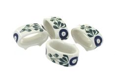 four ceramic rings with blue and white designs on them