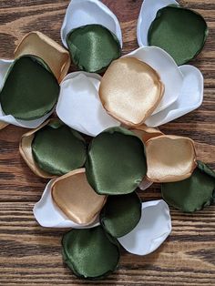 several pieces of green and white fabric sitting on top of each other in small bowls