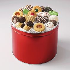 a red tin filled with lots of different types of donuts