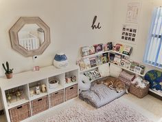 a dog laying on top of a bed in a room with bookshelves and baskets