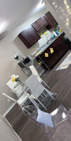 a kitchen and dining room are reflected in the glass doors on the door way to the living room