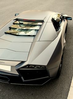 a silver sports car is parked on the street