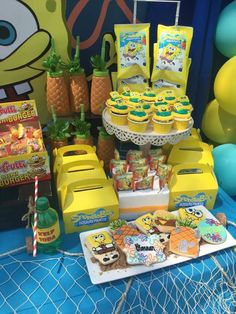 the table is decorated with spongebob cookies and pineapples