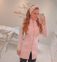 a woman taking a selfie with her cell phone in a dentist's office