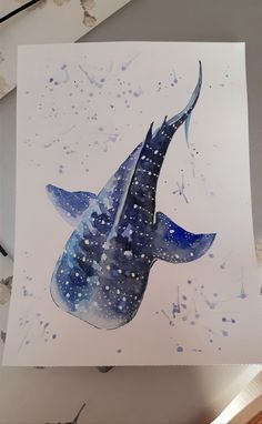 a watercolor painting of a whale swimming in the ocean with stars on it's tail