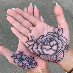 two hand tattoos with flowers on them