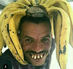 a man wearing a bunch of bananas on top of his head with teeth and mustache