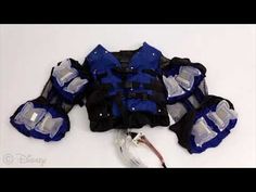 a blue and black life jacket laying on top of a white surface