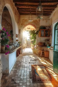 an alley way with potted plants on either side and sunlight coming through the window