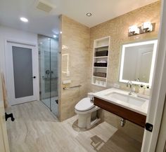 a bathroom with a toilet, sink and shower stall in the middle of it's walls