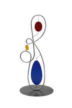 a metal sculpture with two different colored balls